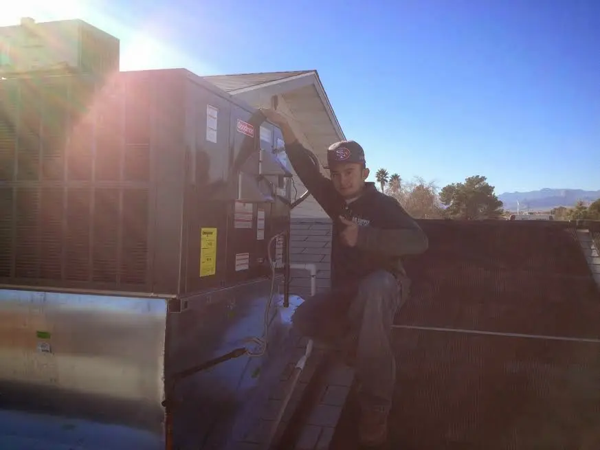 HVAC technician performing AC Tune-Up on a rooftop unit in Halifax
